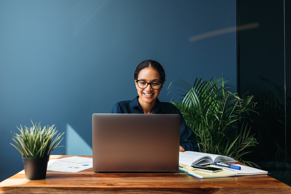 Woman sitting at table using a laptop