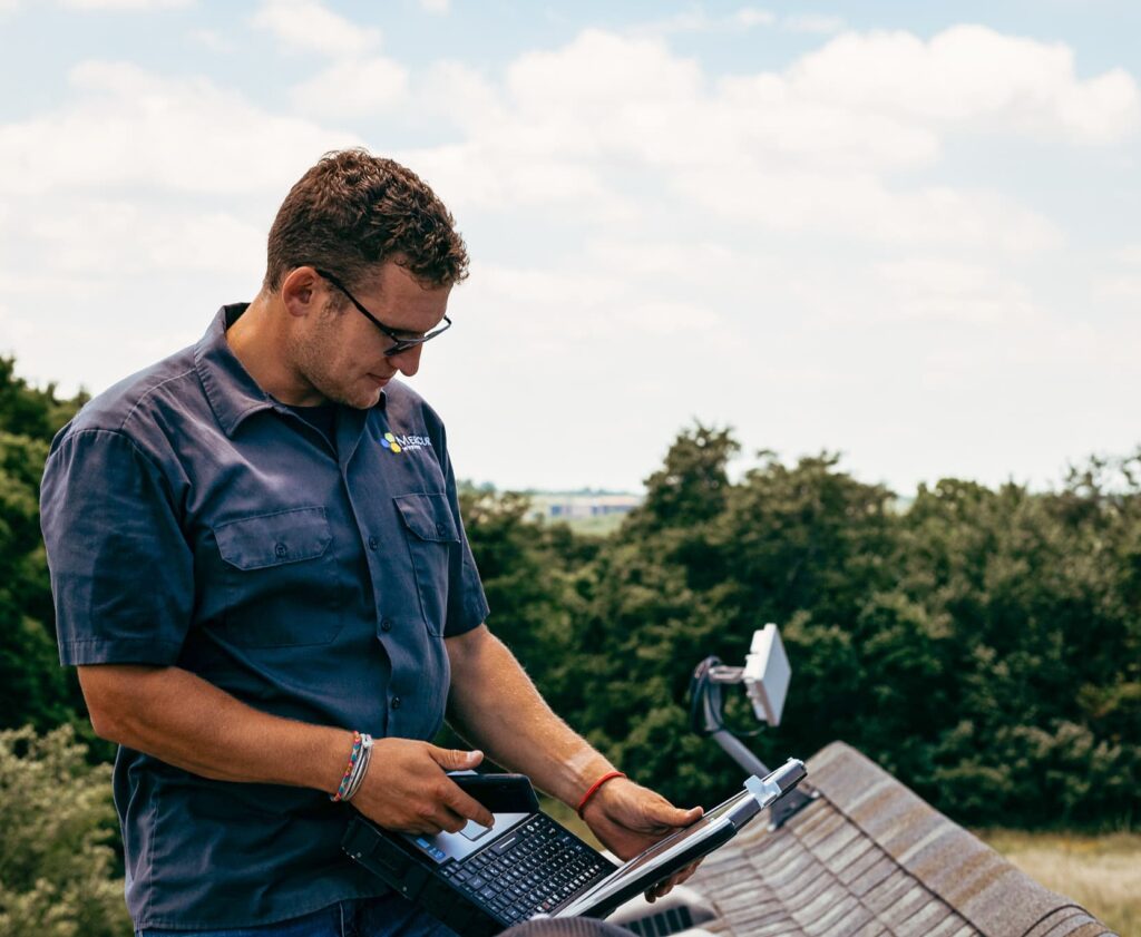 mercury technician standing on roof