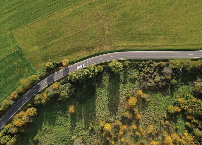 aerial view of road with singular car