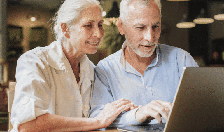 man and woman sitting with laptop