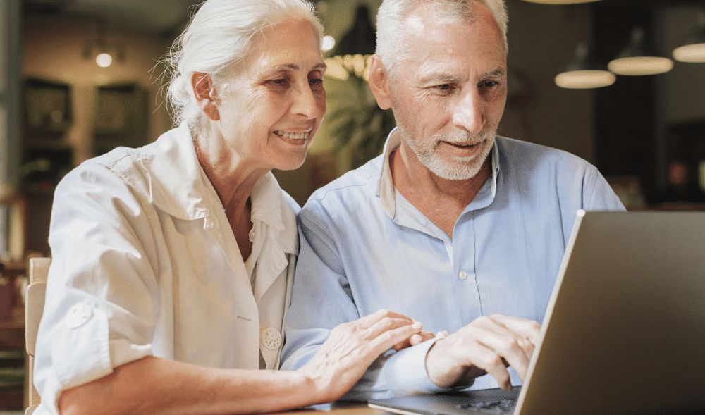 man and woman sitting with laptop
