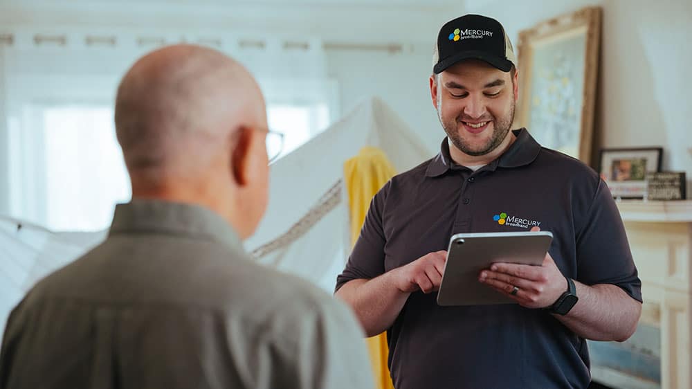 Mercury service technician discussing home internet services
