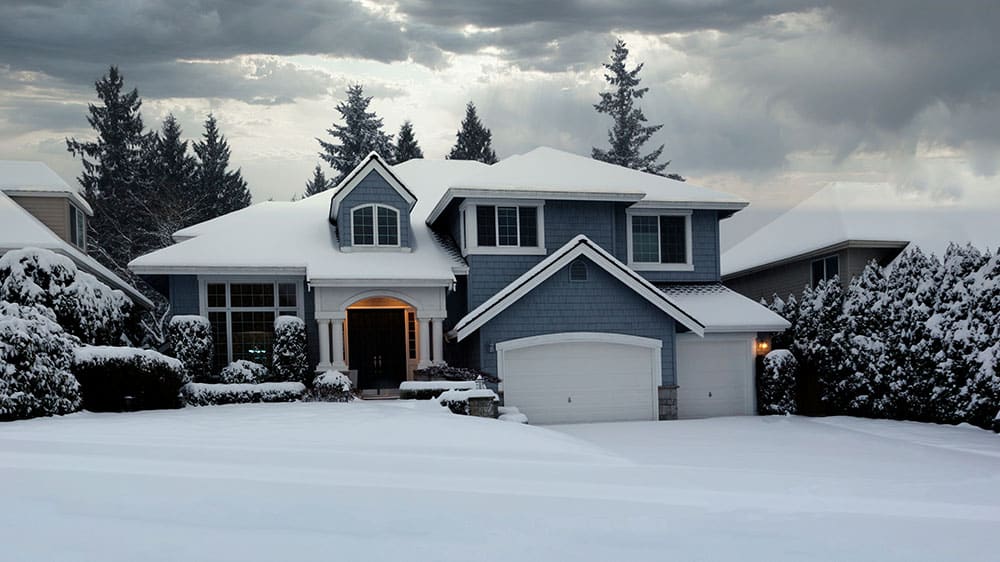 house with snow covered yard scene