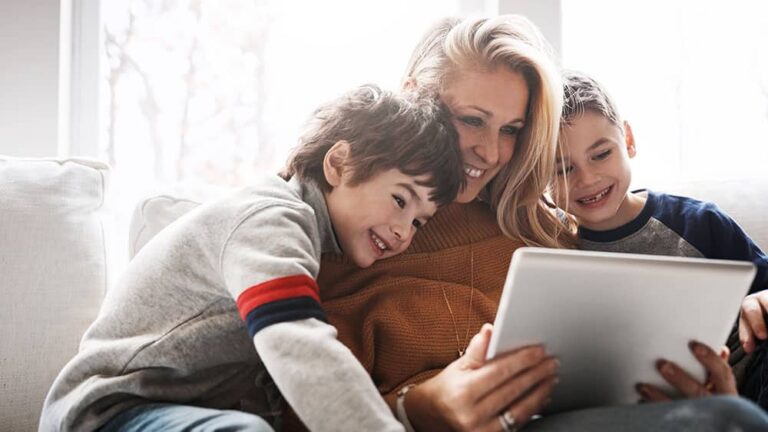 woman sitting on couch with 2 children