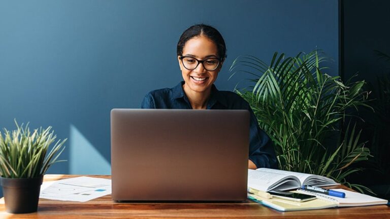 woman sitting at desk with laptop