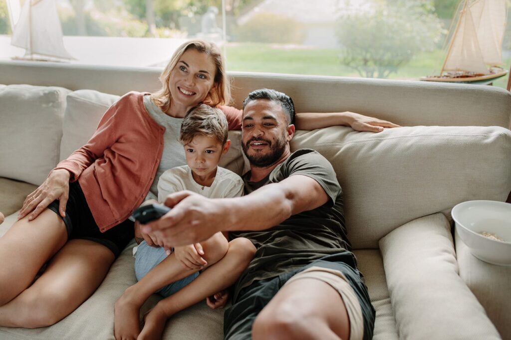 Family watching TV on couch