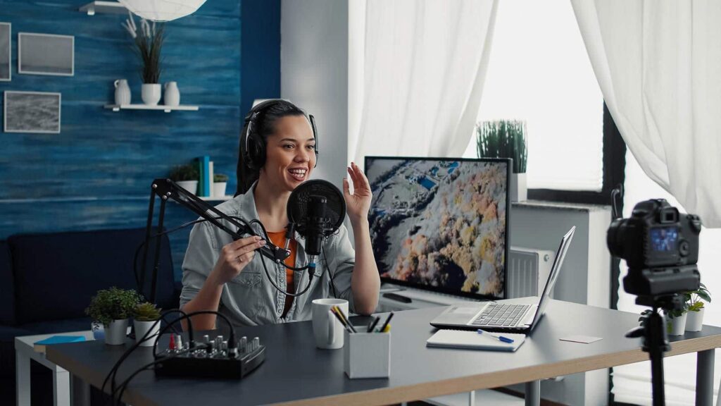 woman sitting at podcast microphone