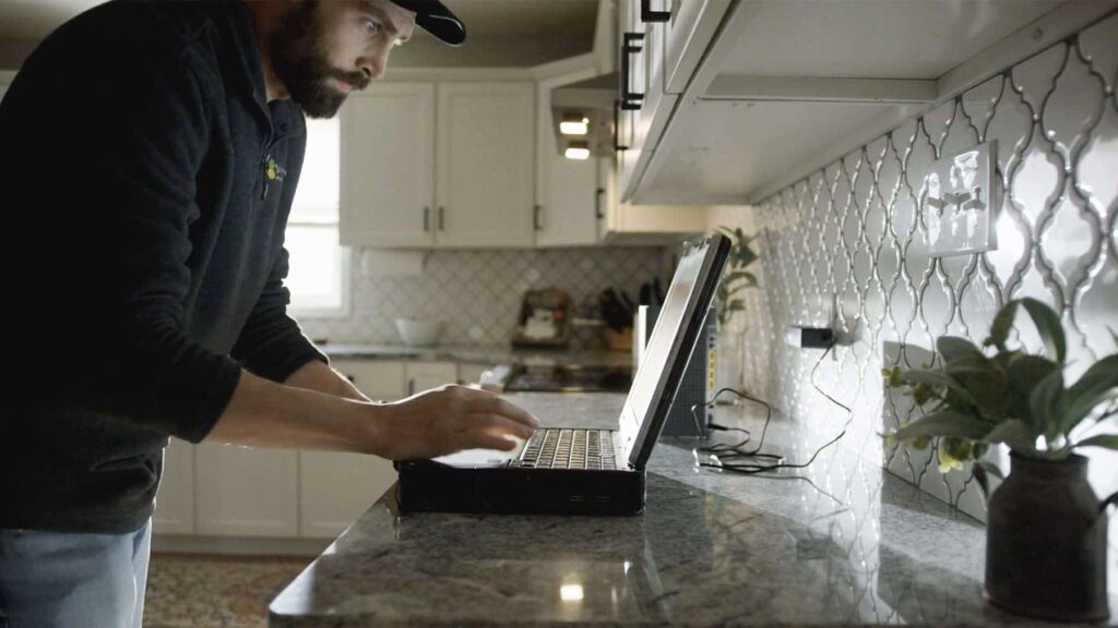 mercury install technician looking at computer