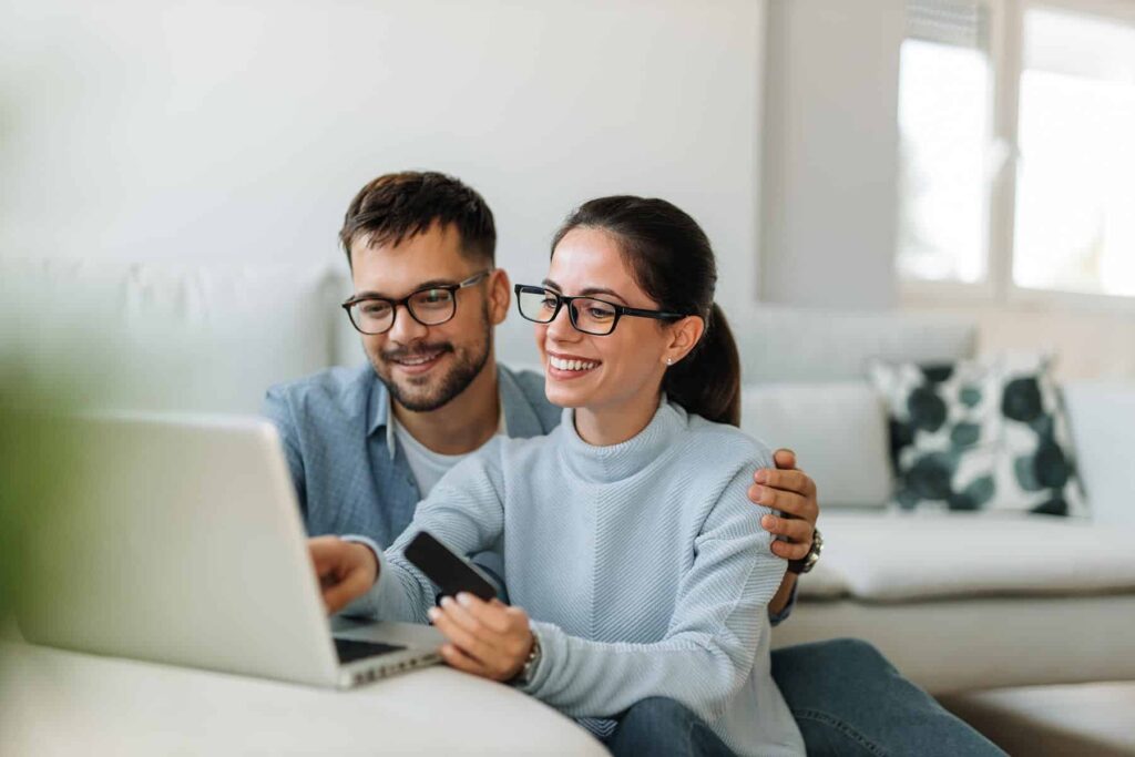 man and woman looking at computer