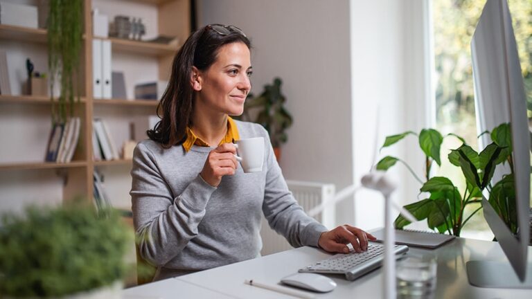 woman sitting at desk looking at computer enjoying fast home internet from Mercury