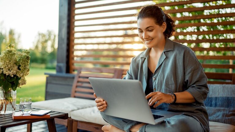 woman sitting outside with laptop enjoying fast home internet from Mercury