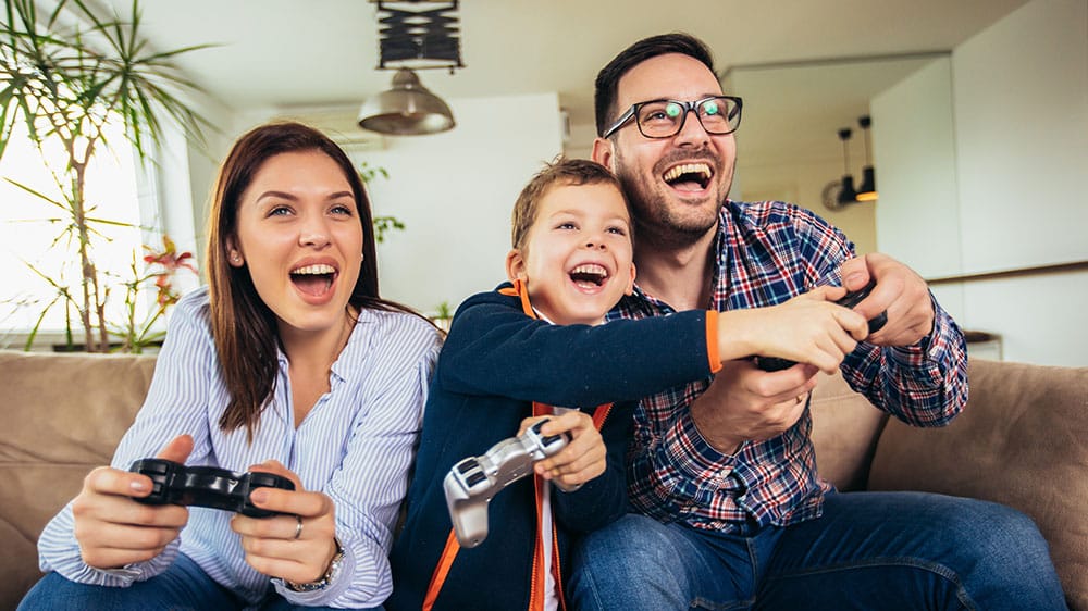 family playing video games together on couch