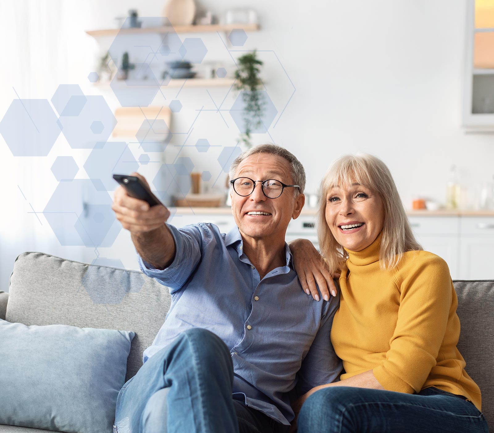 Elderly Couple watching TV on couch